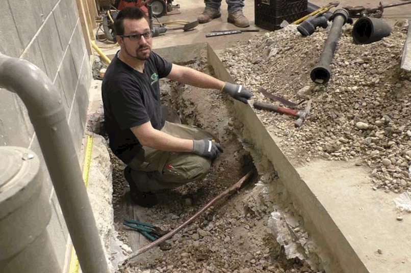 Plumber working on new copper line